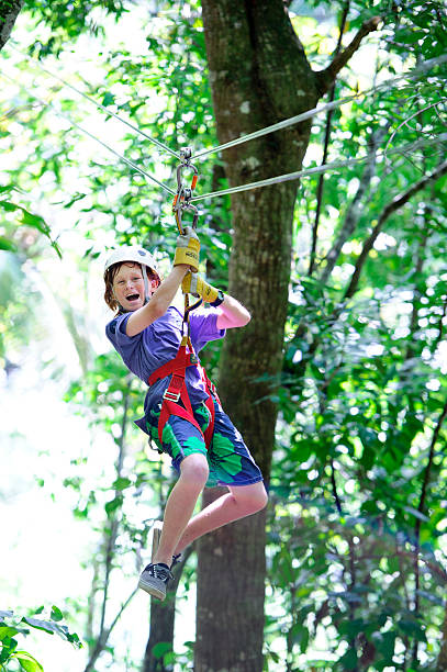 Ocho Rios. Young boy doing the zipline in the rain forest