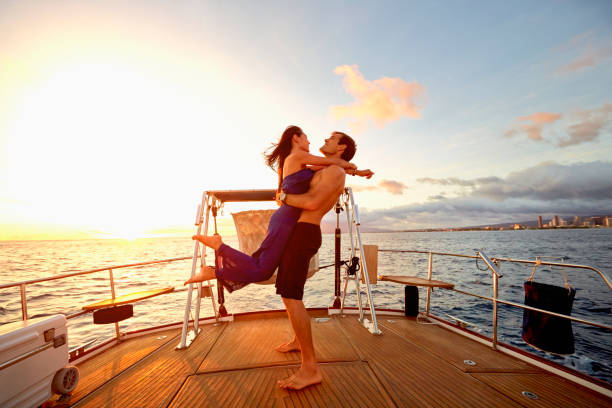 Couple playing on yacht deck Hawaii For Honeymoon